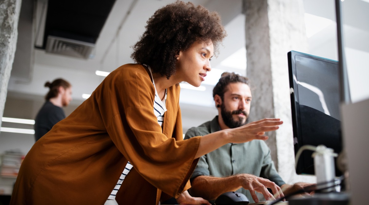 marketing team members working together in an office to create a marketing plan for a manufacturing business that aligns with the businesses goals and objectives.