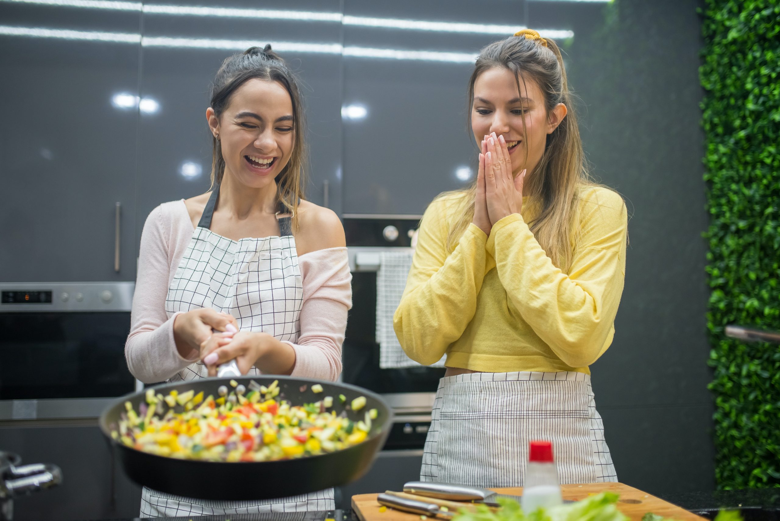Two happy women cooking