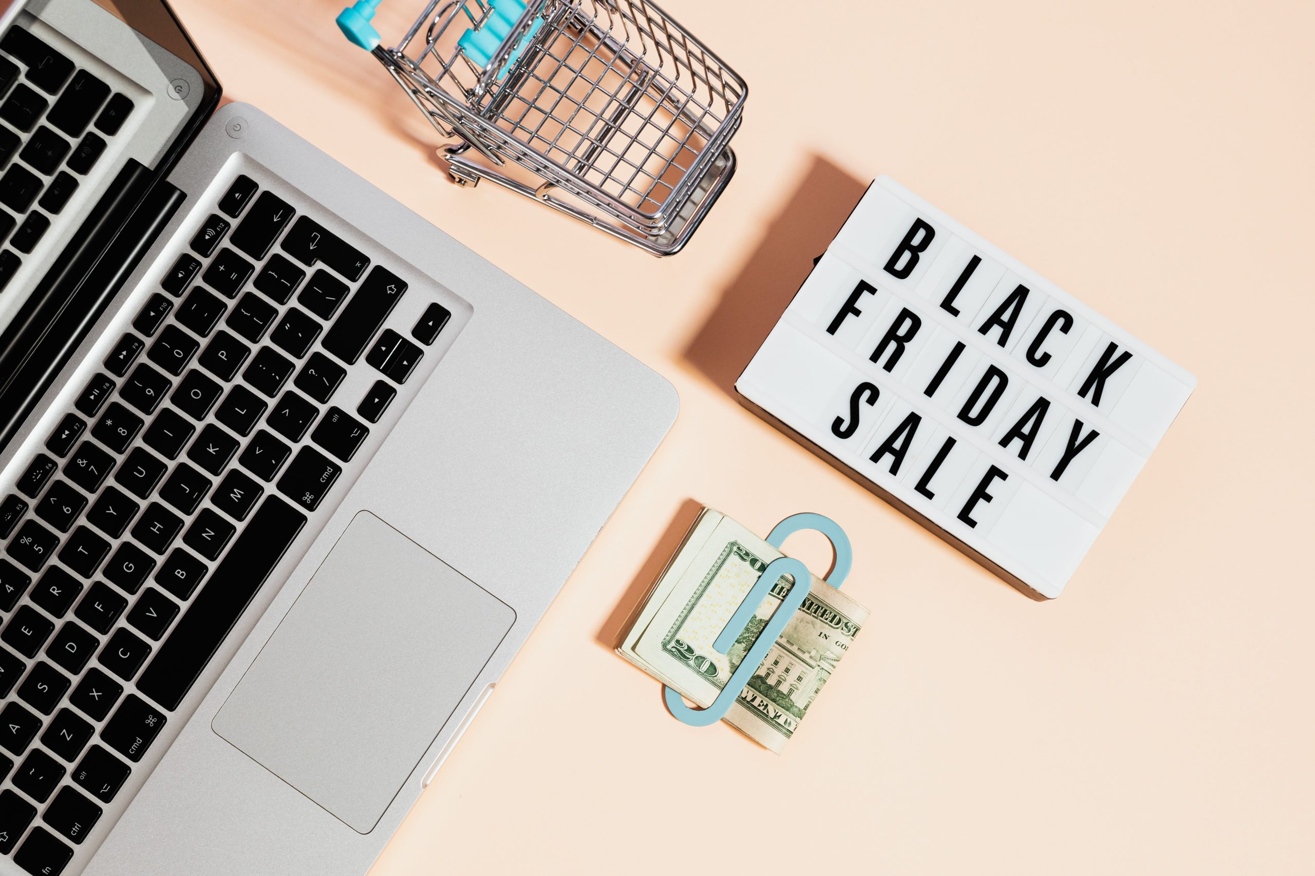 birdseye view of laptop with shopping cart and "black Friday sale" sign